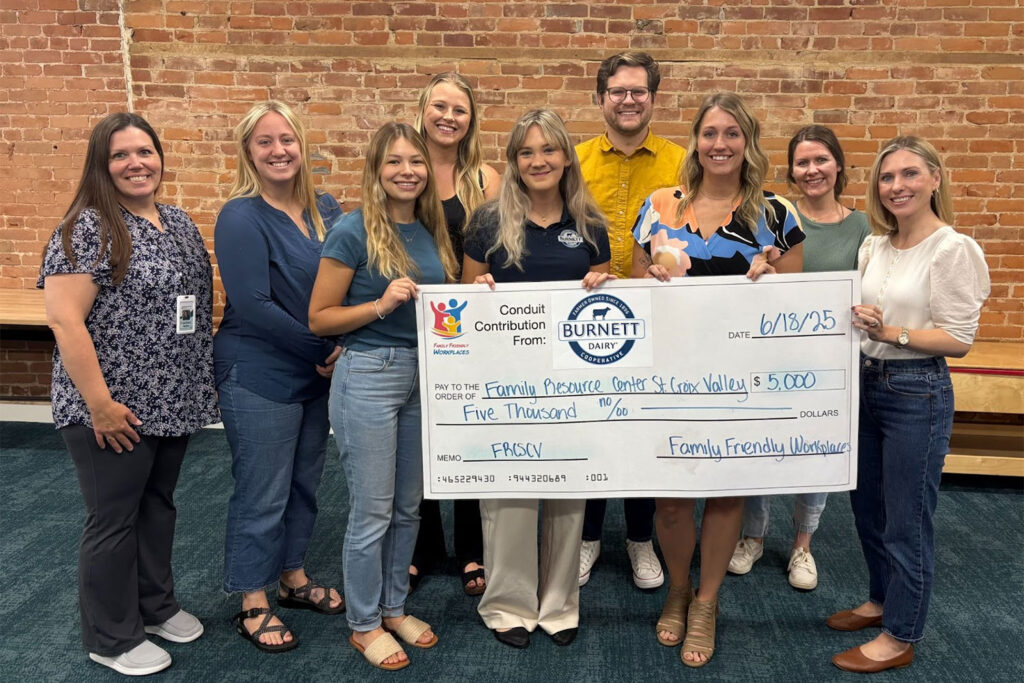 Pictured with the 5,000 check from Burnett Dairy to Family Resource Center St. Croix Valley check are: Pictured left to right were: Courtney Arens (Administrative Assistant, FRCSCV), Analis Rechtzigel (Parent Educator, FRCSCV), Brianna Mayer (Marketing Assistant, Family Friendly Workplaces), Cheyenne Carlson (Parent Educator, FRCSCV), Kelsie Hove (Marketing Intern,  Burnett Dairy Cooperative), Neil Kline (Executive Director, Family Friendly Workplaces), Ashley Ward (Marketing Coordinator, Burnett Dairy Cooperative), Karia Ristow (Parent Educator, FRCSCV), and Jen Jones (Business Manager, FRCSCV)
