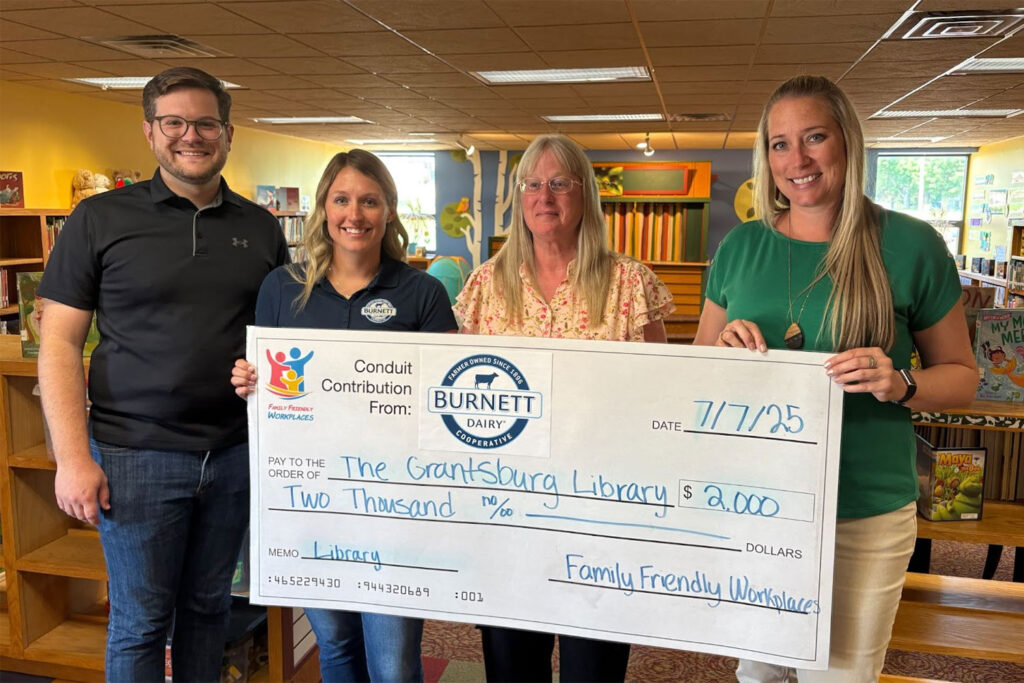 Pictured with the Burnett Dairy Cooperative's $2000 check to The Grantsburg Library are (left to right): Neil Kline (Executive Director, Family Friendly Workplaces), Ashley Ward (Marketing Coordinator, Burnett Dairy Cooperative), Lynett Yoerg (Director, Grantsburg Library), and Alison Hoefs (CHRO, Burnett Dairy Cooperative)