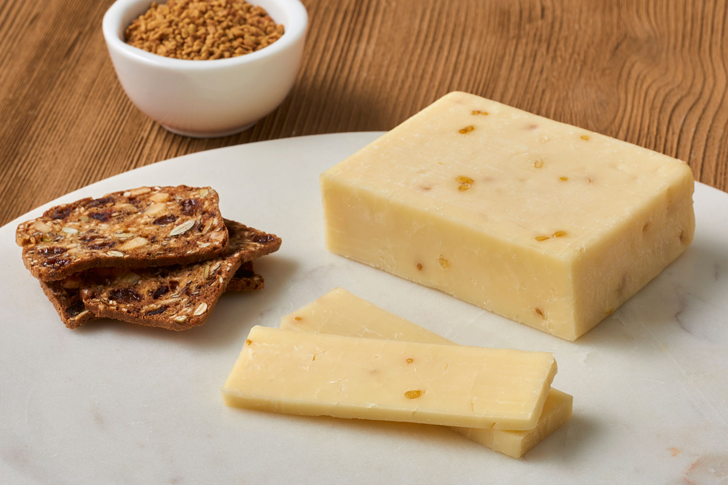 Wood River Creamery cheese and seed bread rest on a marble cutting board